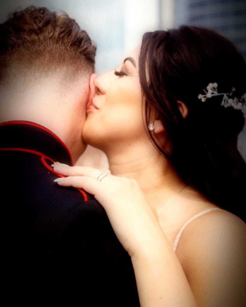 Close-up of a loving couple sharing a tender kiss outdoors.