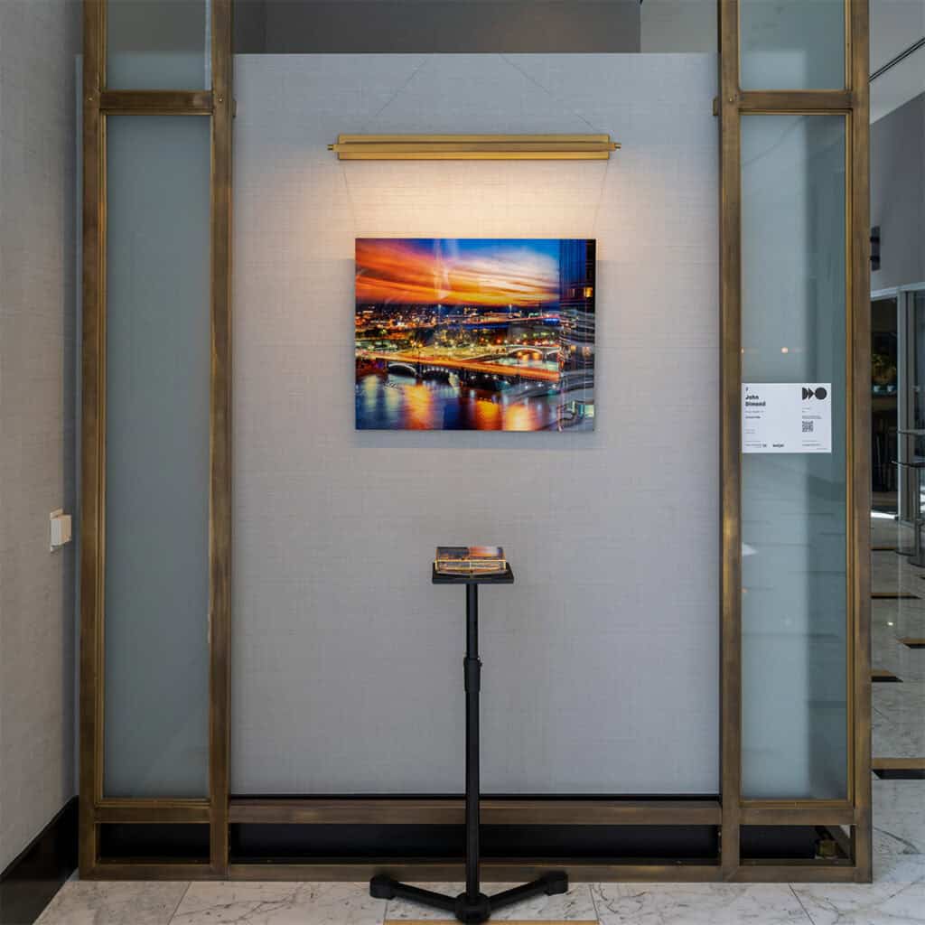 Artprize art installation at the JWMarriott featuring a vibrant cityscape of Grand Rapids MI photograph on a wall.
