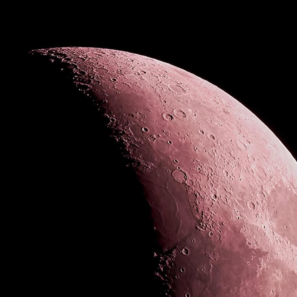 Close-up of the moon's cratered surface, highlighting lunar details.