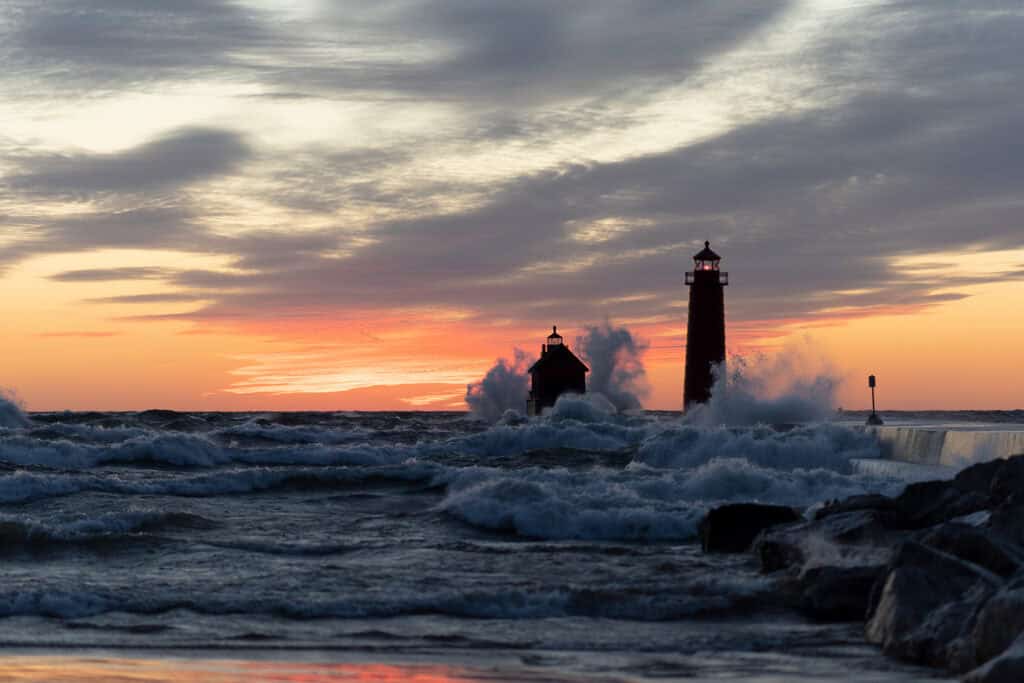 Lighthouse with crashing waves at the Grand Haven State Park MI at sunset, part of the Festival of the Arts exhibition.